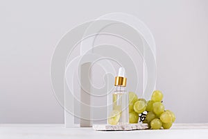 Skin care. Serum with grape seed extract on the background of arches. Copy space