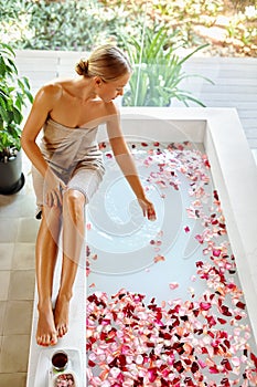 Skin Care Spa Treatment. Woman On Bathtub. Flower Rose Bath.