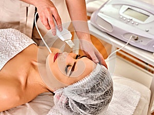Skin care of ultrasound facial peeling. Ultrasonic cleansing procedure.