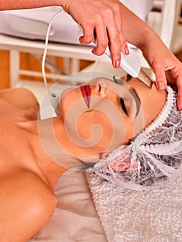 Skin care of ultrasound facial peeling. Ultrasonic cleansing procedure.