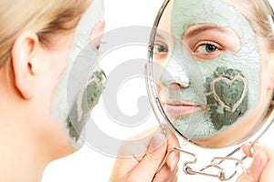 Skin care. Woman in clay mud mask on face. Beauty.