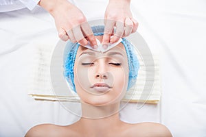 Skin care - woman cleaning face by beautician photo