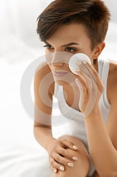 Skin Care. Woman Removing Face Makeup, Cleansing Beauty Face