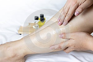 Skin care women legs with skin care products.