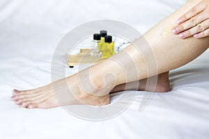 Skin care women legs with skin care products.