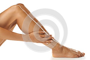 Skin, legs and woman in studio for beauty, wellness and grooming against a white background. Skincare, leg and model