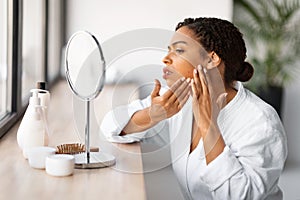 Skin Problems. Stressed Black Woman Looking In Mirror At Pimples On Cheek