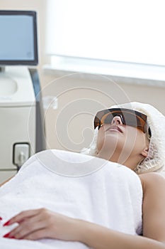 Skin Rejuvenation Concept. Young Caucasian Winsome Woman Getting IPL Laser and Ultrasound Facial Treatment in Modern Medical Spa