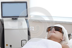 Skin Rejuvenation Concept. Young Caucasian Winsome Woman Getting IPL Laser and Ultrasound Facial Treatment in Modern Medical Spa