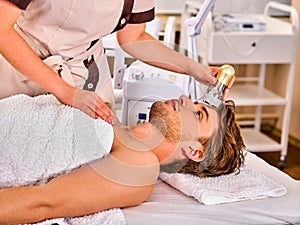 Skin resurfacing procedure facial procedure on ultrasound face machine. photo