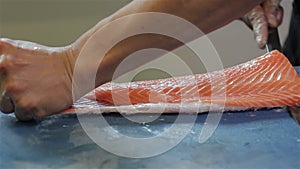 Skin a salmon fillet with a sharp knive.