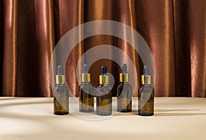 Skincare beauty cosmetic concept. White tube of antioxidant facial oil on brown background