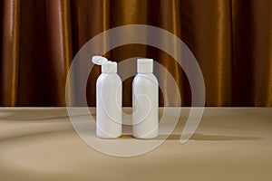 Skincare beauty cosmetic concept. White tube of cream lotion cleanser antioxidant facial oil on brown background