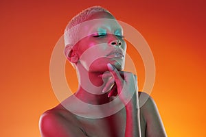 Skincare, beauty and eyes closed, woman with neon makeup and light for creative advertising on orange background