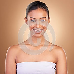 Skincare, beauty and portrait of Indian woman with smile for wellness, natural skin and facial treatment in studio