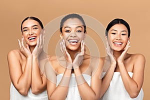 Three Girls Touching Face With Smooth Skin On Beige Background photo