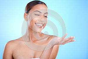 Skincare beauty, woman and hand with mockup space for natural cosmetics product by blue background. Happy model, skin