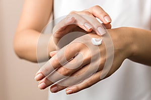 Skincare. close up view of woman hand moisturising them with cream. skincare