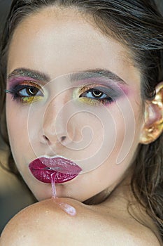 Skincare, cosmetics and visage. Woman run saliva from mouth with purple lips, makeup. Woman with fresh skin face