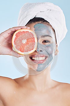 Skincare, face mask and grapefruit with a woman during her skin routine for clean and clear complexion. Young model with