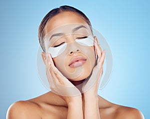 Skincare, mask for eyes and face of woman on blue background for wellness, cosmetics and facial treatment. Beauty