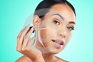 Skincare, oil and portrait of woman in studio for beauty, wellness or cosmetic on blue background. Face, serum and girl