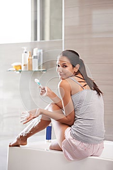 Skincare, portrait and confused woman shaving legs in bathroom for hair removal, hygiene or smooth skin at home. Beauty