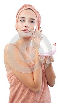 Skincare, pretty young woman applying moisturizing cream on face, lotion or mask for skin lifting and anti-aging, wears wrapped