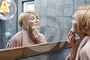 Skincare Routine. Anti Aging Beauty Treatment Concept. Mature Woman Cleans Face Skin With Cotton Pads.