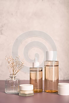 skincare set of dropped bottle , jar and toner. self care and cosmetic concept . Vertical beauty background with copy space