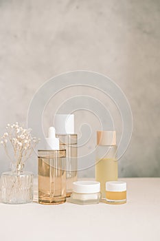 skincare set product with flower in the bathroom with copy space. vertical