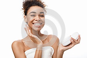 Skincare. Woman applying face cream holding jar with balm