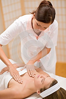 Skincare - woman cleavage massage at salon