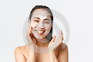 Skincare, women beauty, hygiene and personal care concept. Close-up of happy smiling asian woman standing naked in bath