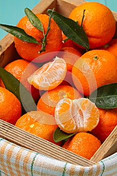 Skinless and fresh tangerines on a turquoise table