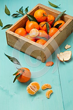 Skinless and fresh tangerines on a turquoise table