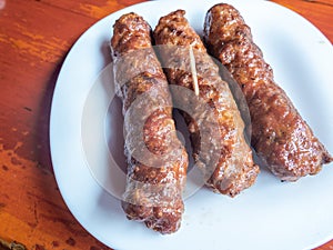 Skinless meat roll sausage or mici traditional balkan romanian ottoman cuisine delicacy served with mustard