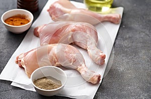 Skinless Raw chicken legs on white paper. Raw chicken legs for barbecue or soup. Fresh raw chicken legs