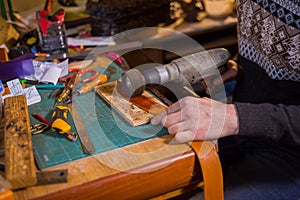 Skinner working with leather belt