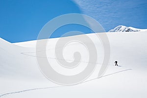 Skinning up the Asulkan Glacier in Glacier National Park, British Columbia. A man hikes on skis to access the Seven Steps to