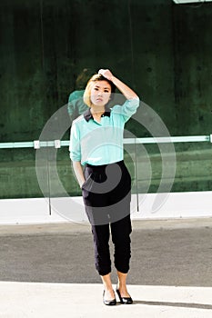 Skinny Asian American Woman Outdoors Pants And Shirt