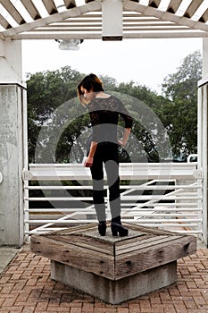 Skinny Asian American Woman Standing Black Pants