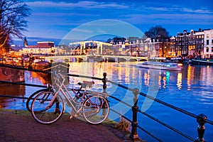 Skinny bridge and Amstel river in Amsterdam Netherlands at Dusk