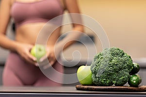 Skinny Girl Dieting Standing In Kitchen, Focus On Vegetables, Cropped