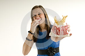 Skinny girl eating french fries