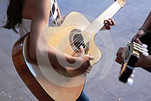 Skinny guitar player with an acoustic guitar