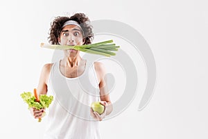 Skinny guy eats only vegetables photo