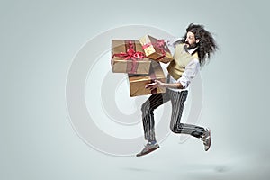 Skinny man running with the bunch of presents