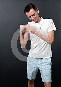 Skinny man showing his muscles