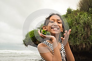 Skinny Southeast Asian teen girl having fun on the beach